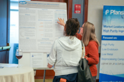 Showcase Your Research: This image shows two professionals pointing at and discussing a scientific poster